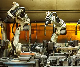 Robotic arms working in an industrial setting.