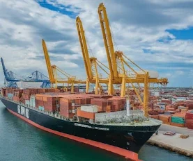 Container ship docked at port with cranes